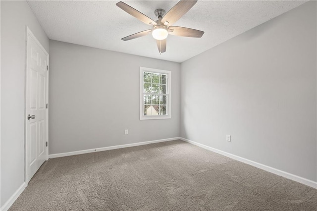 empty room featuring ceiling fan, carpet, baseboards, and a textured ceiling