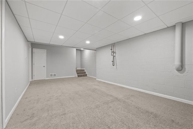 finished basement featuring stairway, recessed lighting, visible vents, and carpet floors