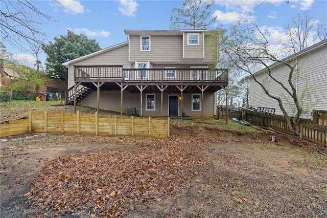 back of property with a deck, central air condition unit, and a fenced backyard