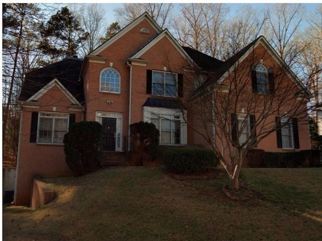 7071 Glen Cove Ln, Stone Mountain, GA 30087 - traditional-style house featuring a front lawn and brick siding