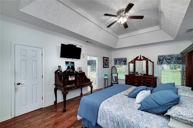 bedroom featuring ceiling fan, a raised ceiling, dark wood-type flooring, and a textured ceiling