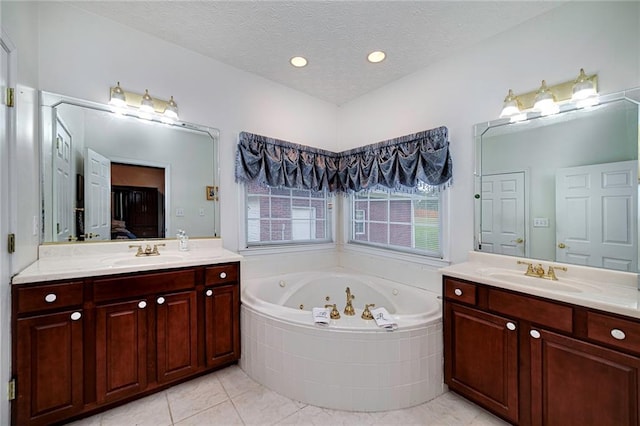 bathroom with a textured ceiling, double sink, and large vanity