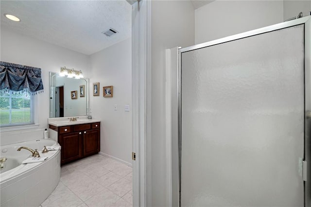 bathroom featuring a textured ceiling, shower with separate bathtub, tile floors, and oversized vanity