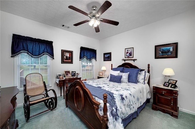 bedroom with carpet flooring, a textured ceiling, and ceiling fan