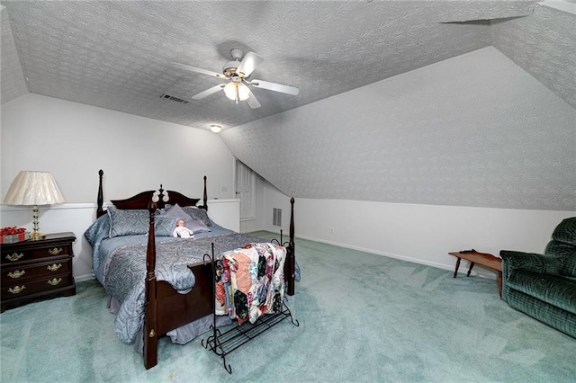 bedroom with vaulted ceiling, carpet flooring, ceiling fan, and a textured ceiling