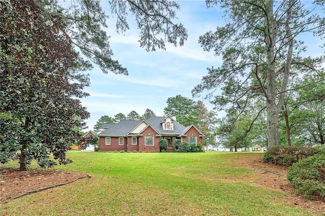 cape cod home featuring a front yard