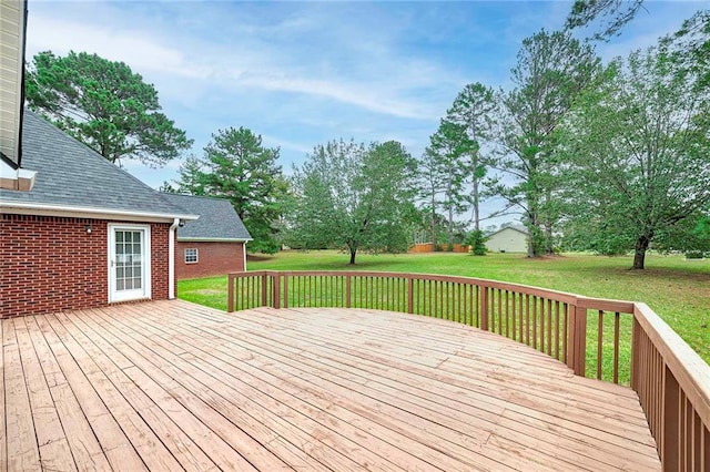 wooden terrace featuring a lawn