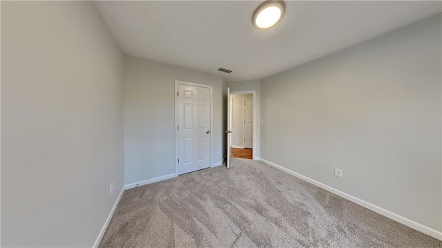 spare room featuring light colored carpet