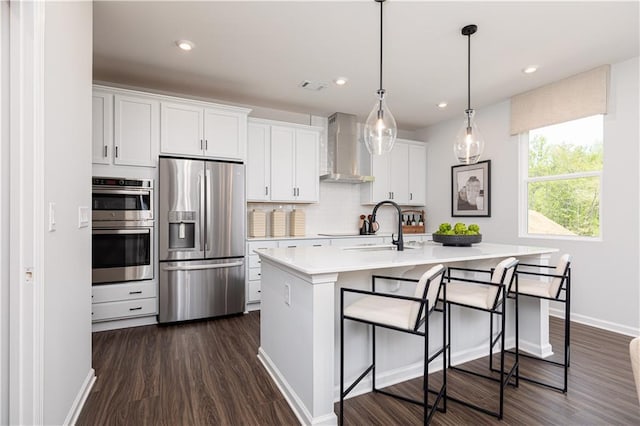 608 Belshire Dr, Acworth, GA 30102 - kitchen with stainless steel appliances, wall chimney range hood, dark wood-style flooring, light countertops, and recessed lighting