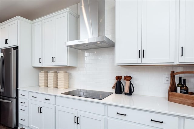608 Belshire Dr, Acworth, GA 30102 - kitchen with wall chimney exhaust hood, black electric stovetop, freestanding refrigerator, white cabinetry, and light countertops