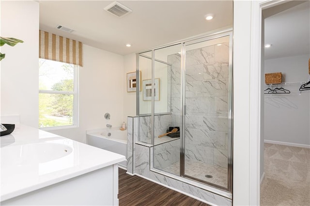 608 Belshire Dr, Acworth, GA 30102 - full bath with a stall shower, vanity, recessed lighting, a spacious closet, and a garden tub