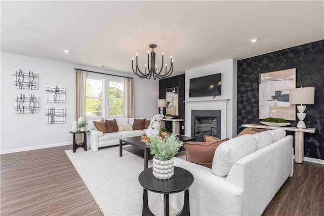 608 Belshire Dr, Acworth, GA 30102 - living area with a chandelier, a glass covered fireplace, dark wood-type flooring, recessed lighting, and an accent wall