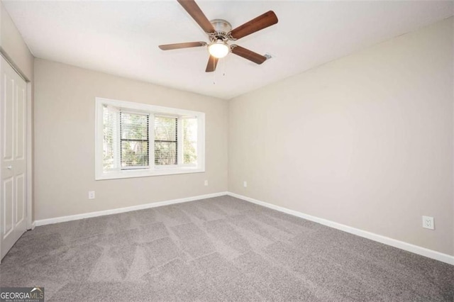 unfurnished bedroom with carpet, baseboards, a closet, and a ceiling fan