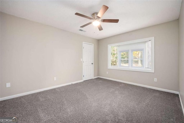 empty room with carpet, baseboards, and ceiling fan