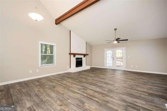 unfurnished living room featuring high vaulted ceiling, a ceiling fan, dark wood finished floors, beamed ceiling, and a large fireplace