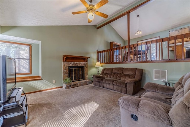 carpeted living room featuring baseboards, visible vents, ceiling fan, vaulted ceiling with beams, and a fireplace