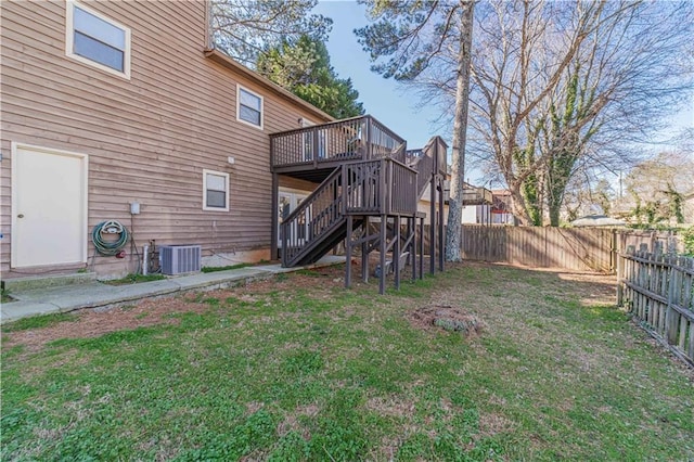 back of house featuring a lawn, stairway, central AC, a deck, and a fenced backyard