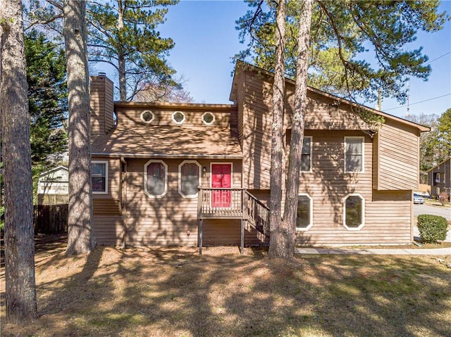 view of front of property with a chimney and a front yard