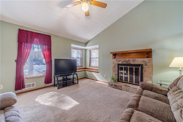 carpeted living room with vaulted ceiling, visible vents, plenty of natural light, and a textured ceiling