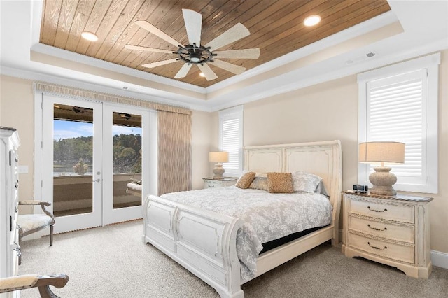 bedroom featuring ceiling fan, a tray ceiling, and access to outside