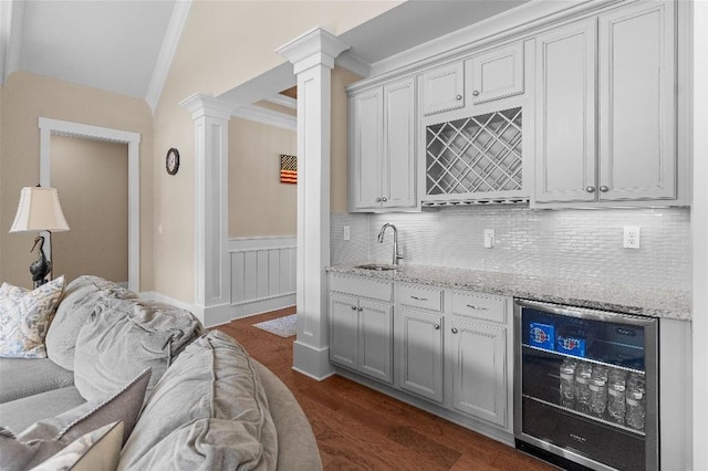 kitchen featuring wine cooler, dark hardwood / wood-style flooring, crown molding, and tasteful backsplash