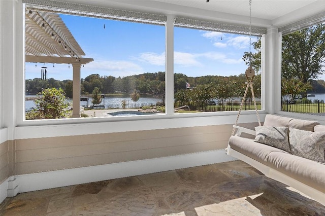 sunroom featuring a water view and a healthy amount of sunlight