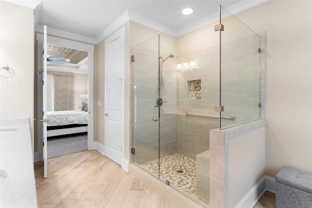 bathroom featuring wood-type flooring, an enclosed shower, and ornamental molding