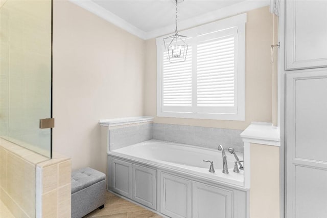 bathroom with separate shower and tub, a chandelier, and ornamental molding