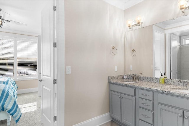 bathroom featuring ceiling fan, a wealth of natural light, ornamental molding, and vanity