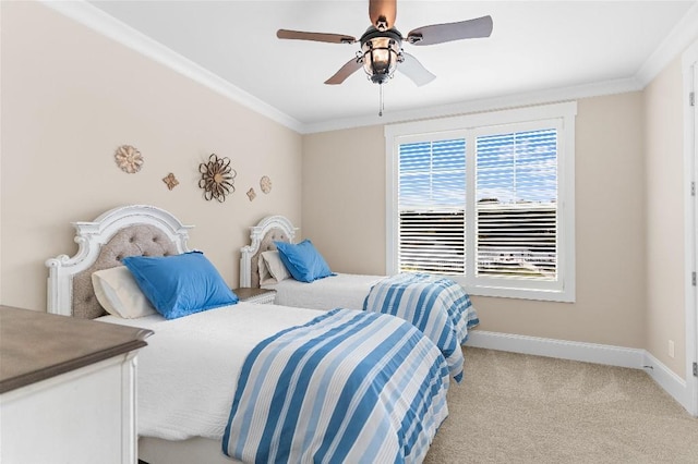 carpeted bedroom with ceiling fan and ornamental molding