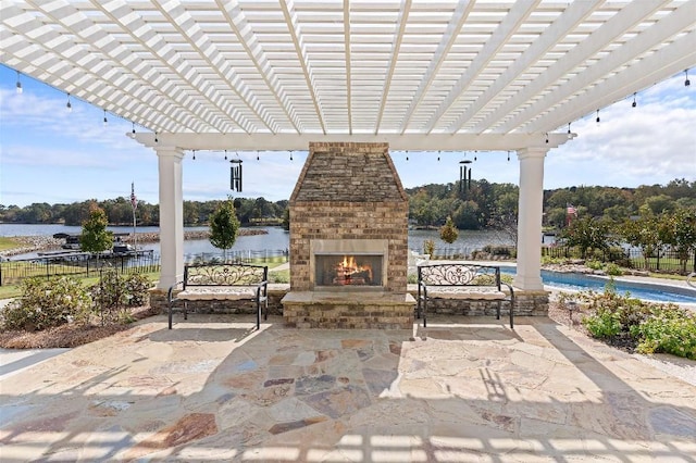 view of patio with a water view, an outdoor brick fireplace, and a pergola