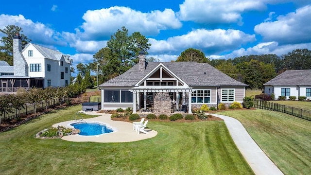 back of house featuring a pergola, a hot tub, a yard, and a patio