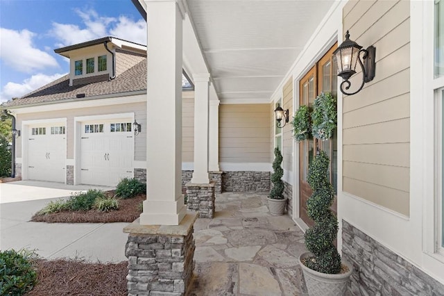 exterior space with covered porch and a garage