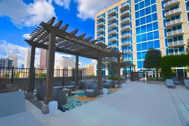 view of community with a patio area, a pergola, and outdoor lounge area