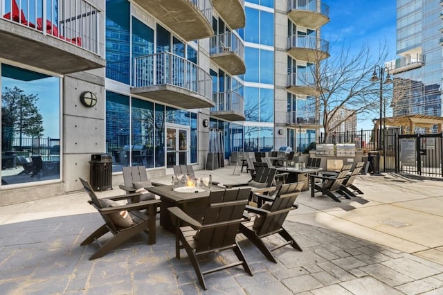 view of patio / terrace with a balcony and a fire pit