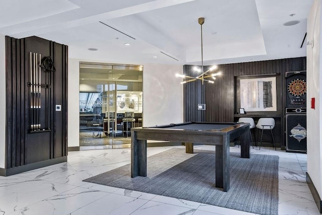 recreation room featuring pool table, wooden walls, and a chandelier