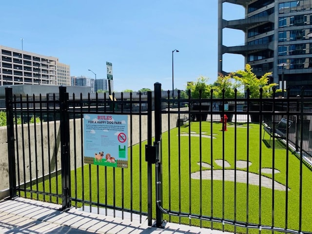 view of gate with a lawn