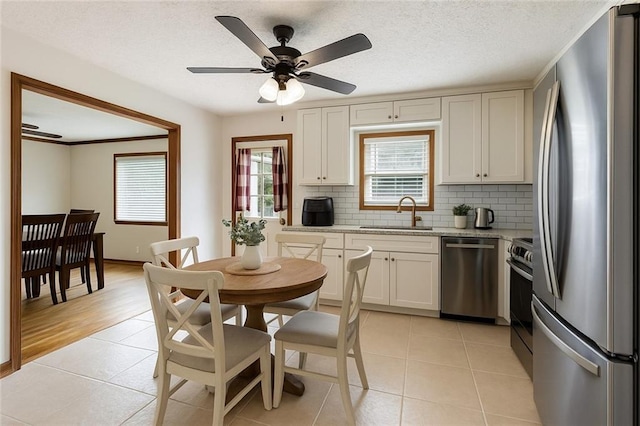 319 Hill Crest Cir, Woodstock, GA 30188 - kitchen featuring appliances with stainless steel finishes, a sink, tasteful backsplash, and light tile patterned floors
