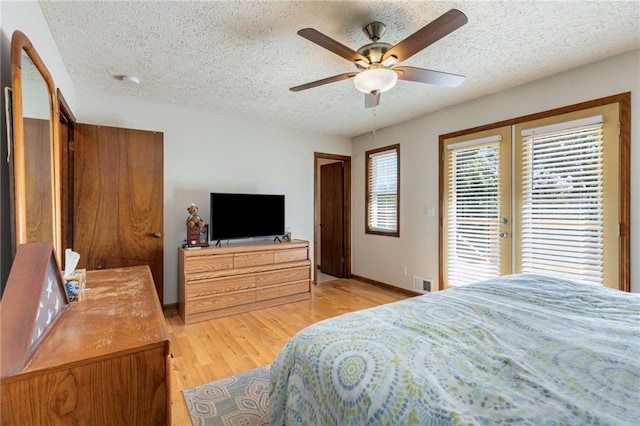 319 Hill Crest Cir, Woodstock, GA 30188 - bedroom featuring light wood-style flooring, a textured ceiling, french doors, access to outside, and baseboards