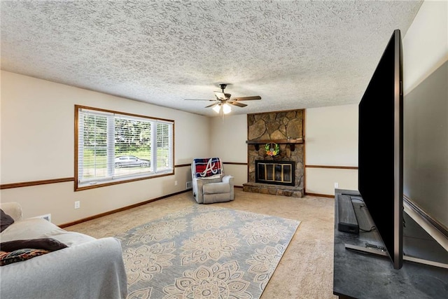 319 Hill Crest Cir, Woodstock, GA 30188 - carpeted living room with a ceiling fan, a stone fireplace, baseboards, and a textured ceiling