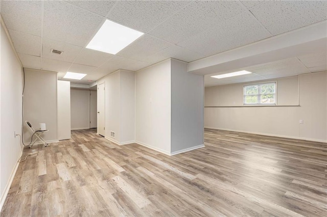 319 Hill Crest Cir, Woodstock, GA 30188 - below grade area with a paneled ceiling, wood finished floors, and baseboards