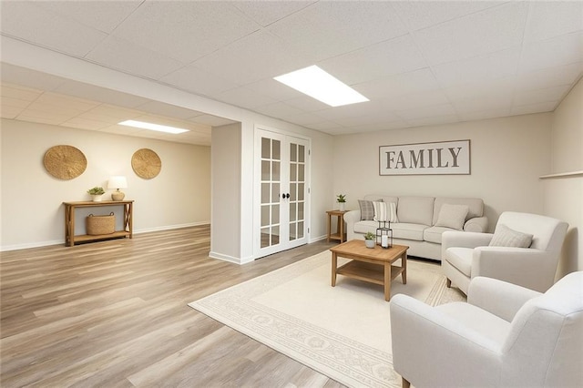 319 Hill Crest Cir, Woodstock, GA 30188 - living area featuring wood finished floors, french doors, baseboards, and a paneled ceiling