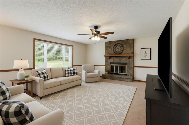 319 Hill Crest Cir, Woodstock, GA 30188 - living area with ceiling fan, a stone fireplace, light carpet, and a textured ceiling
