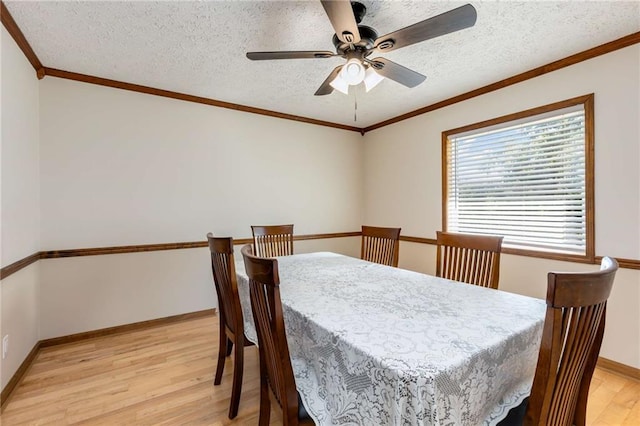 319 Hill Crest Cir, Woodstock, GA 30188 - dining room with light wood finished floors, a ceiling fan, baseboards, a textured ceiling, and crown molding