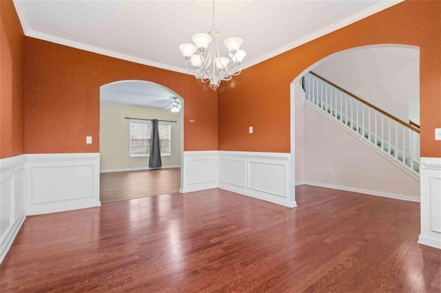 unfurnished room with ceiling fan with notable chandelier, hardwood / wood-style flooring, and crown molding