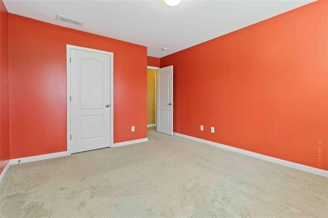 unfurnished bedroom featuring light colored carpet