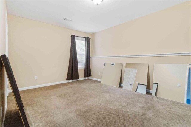 empty room with light colored carpet