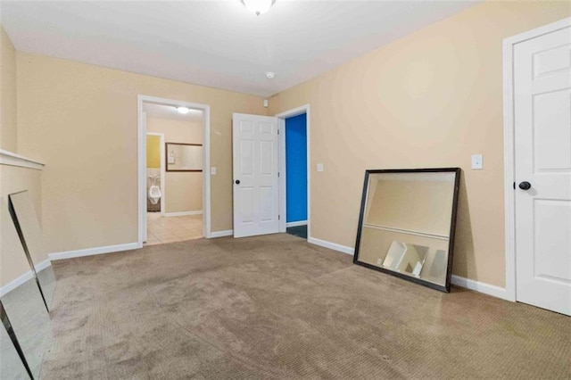 unfurnished bedroom featuring light carpet