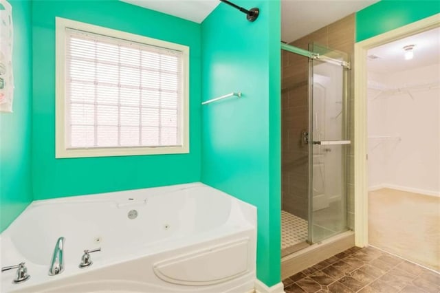 bathroom with independent shower and bath and tile patterned flooring