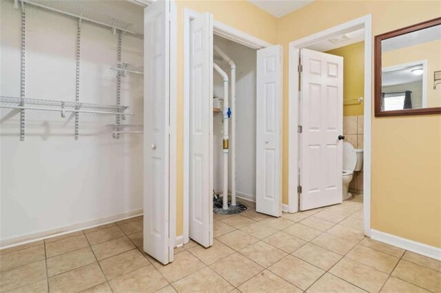 corridor featuring light tile patterned floors